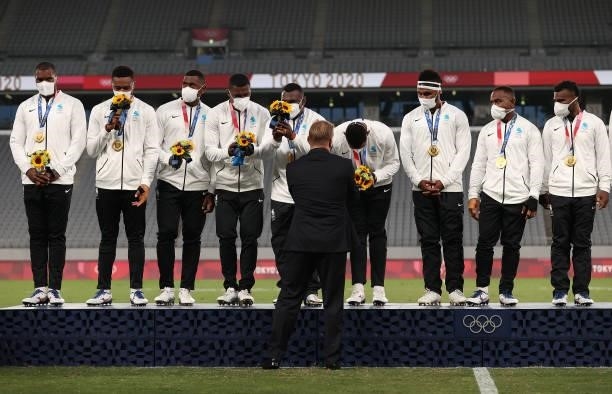 World Rugby CEO Alan Gilpin hands out flowers to Team Fiji after winning the Rugby Sevens Men's Gold Medal match between New Zealand and Fiji on day...