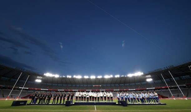 Team New Zealand, Team Fiji and Team Argentina line up for national anthems during the medals ceremony on day five of the Tokyo 2020 Olympic Games at...