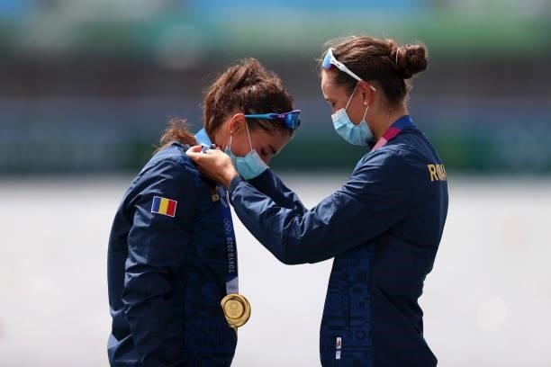 Gold medalists Ancuta Bodnar and Simona Radis of Team Romania place their medals round each others necks during the medal ceremony for the Women's...