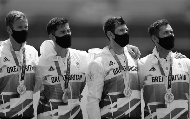 Jack Beaumont, Tom Barras, Angus Groom and Harry Leask of Team Great Britain look on during the national anthem after winning the silver medal during...