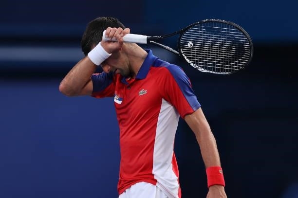 Novak Djokovic of Team Serbia wipes away sweat between points during his Men's Singles Third Round match against Alejandro Davidovich Fokina of Team...