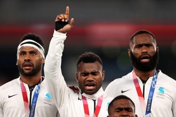 Jerry Tuwai of Team Fiji sings on the podium with his team mates after receiving their gold medals following victory in the Rugby Sevens Men's Gold...