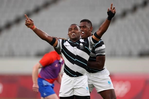 Waisea Nacuqu of Team Fiji celebrates victory with Kalione Nasoko of Team Fiji during the Rugby Sevens Men's Gold Medal match between New Zealand and...