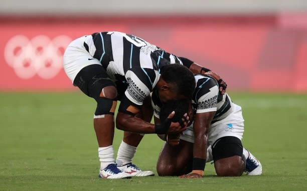 Jerry Tuwai of Team Fiji and Napolioni Bolaca of Team Fiji react on the final whistle following victory in the Rugby Sevens Men's Gold Medal match...