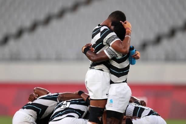 Jerry Tuwai of Team Fiji and Meli Derenalagi of Team Fiji embrace on the final whistle following victory in the Rugby Sevens Men's Gold Medal match...