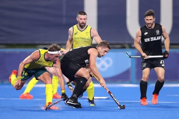 Nick Wilson of Team New Zealand controls the ball whilst under pressure from Tim Howard of Team Australia during the Men's Preliminary Pool A match...