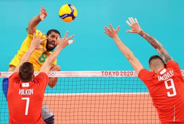 Wallace de Souza of Team Brazil competes against Ivan Iakovlev and Dmitry Volkov of Team ROC during the Men's Preliminary Round - Pool B volleyball...