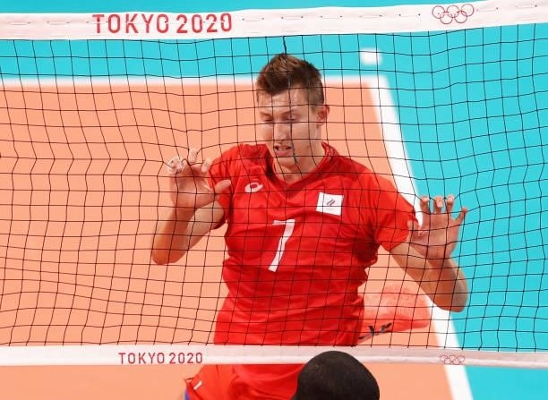 Dmitry Volkov of Team ROC holds onto the net against Team Brazil during the Men's Preliminary Round - Pool B volleyball on day five of the Tokyo 2020...