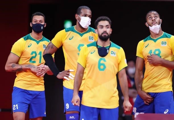 Alan Souza of Team Brazil wears a face mask as he stands on the sidelines with team mates against Team ROC during the Men's Preliminary Round - Pool...