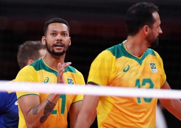 Alan Souza of Team Brazil reacts with team mates against Team ROC during the Men's Preliminary Round - Pool B volleyball on day five of the Tokyo...
