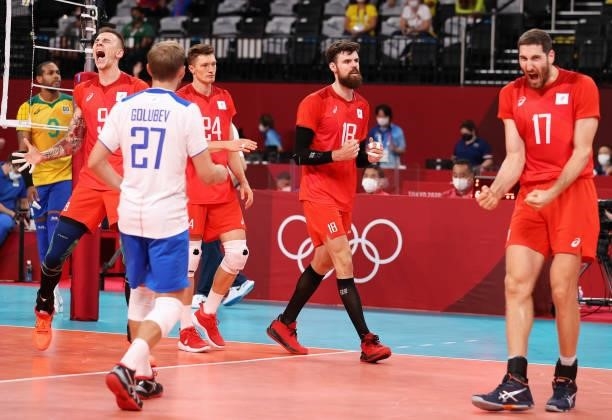 Ivan Iakovlev of Team ROC reacts with team mates after defeating Team Brazil during the Men's Preliminary Round - Pool B volleyball on day five of...