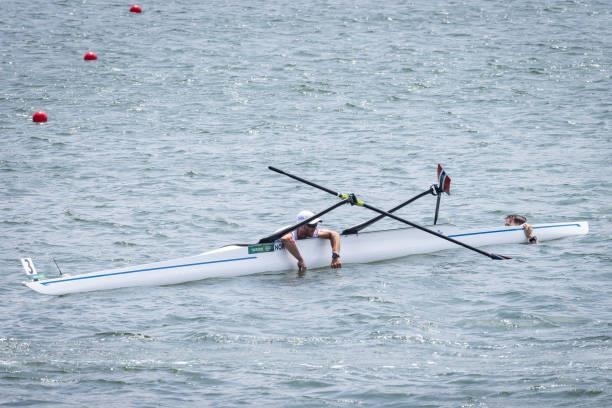 Kristoffer Brun and Are Weierholt Strandli of Team Norway hold on to their capsized boat during the Lightweight Men's Double Sculls Semifinal A/B 1...