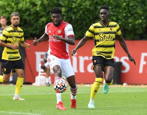 Thomas Partey of Arsenal takes on Ismaila Sarr of Watford during the pre season friendly match between Arsenal and Watford at London Colney on July...