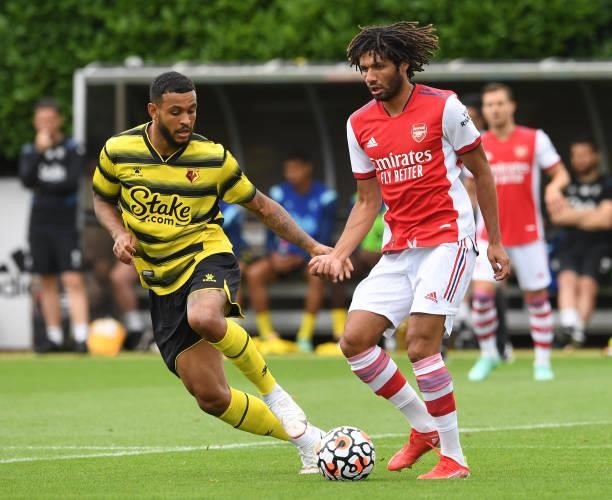Mohamed Elneny of Arsenal passes the ball under pressure from Josh King of Watford during the pre season friendly match between Arsenal and Watford...