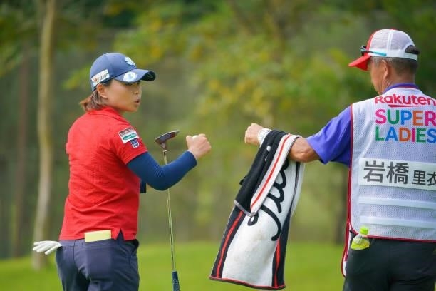 Rie Iwahashi of Japan fist bumps with her caddie on the 4th green during the first round of Rakuten Super Ladies at Tokyu Grand Oak Golf Club on July...