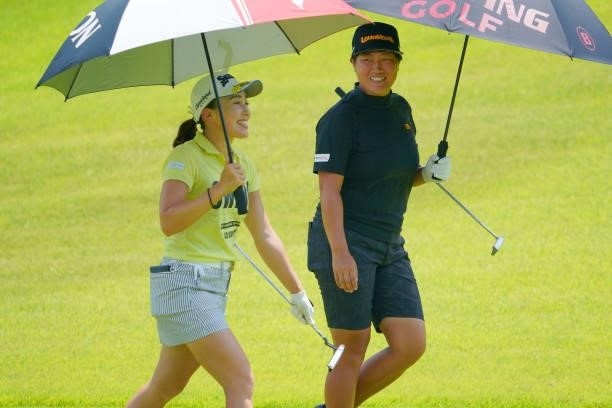 Risa Murata and Haruka Kudo of Japan talk while walking on the 1st fairway during the first round of Rakuten Super Ladies at Tokyu Grand Oak Golf...
