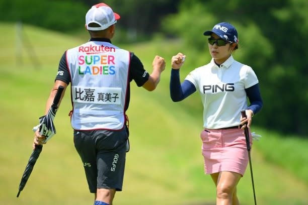 Mamiko Higa of Japan fist bumps with her caddie after the birdie on the 8th green during the first round of Rakuten Super Ladies at Tokyu Grand Oak...