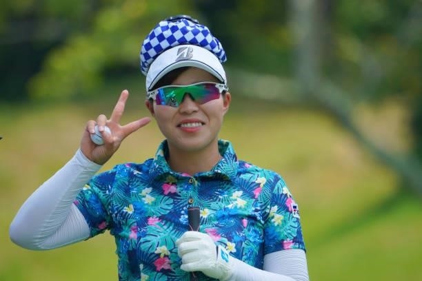 Akane Saeki of Japan poses with an ice bag on her head on the 11th hole during the first round of Rakuten Super Ladies at Tokyu Grand Oak Golf Club...