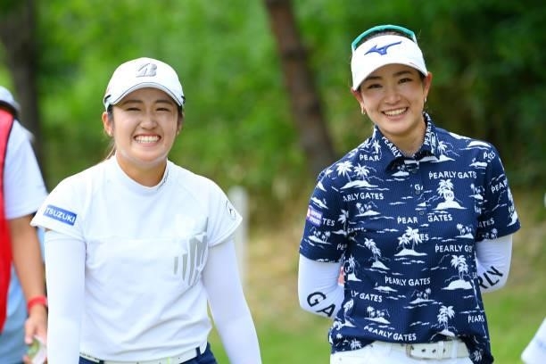 Mone Inami and Erika Hara of Japan return to the club house as the play is suspended due to thunder clouds approaching during the first round of...