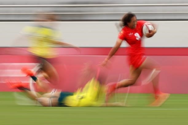 Minglin Tang of Team China breaks away to score a try in the Women’s pool C match between Team Australia and Team China during the Rugby Sevens on...