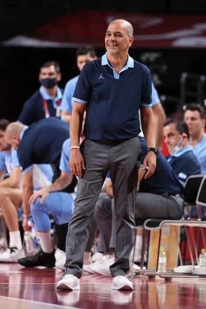 Team Argentina Head Coach Sergio Hernandez smiles as he watches his team from the bench during the second half of their Men's Preliminary Round Group...
