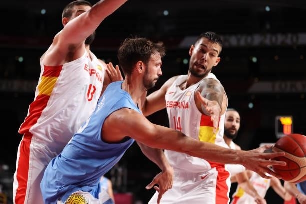 Marcos Delia of Team Argentina passes the ball as he is pressured by Marc Gasol and Willy Hernangomez of Team Spain during the second half of a Men's...