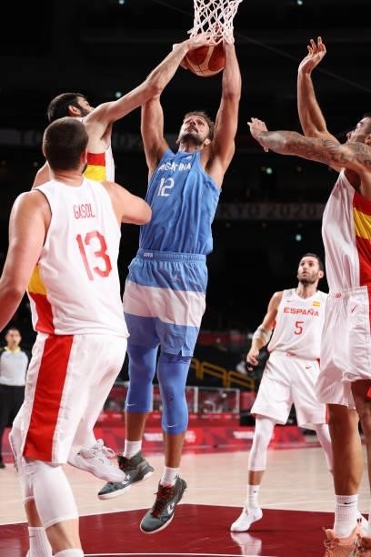 Marcos Delia of Team Argentina is stripped of the ball as he drives to the basket against Spain during the second half of a Men's Preliminary Round...