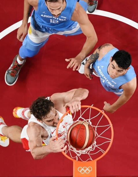 Pau Gasol of Team Spain dunks over Marcos Delia and Gabriel Deck of Team Argentina during the first half of a Men's Preliminary Round Group C game on...
