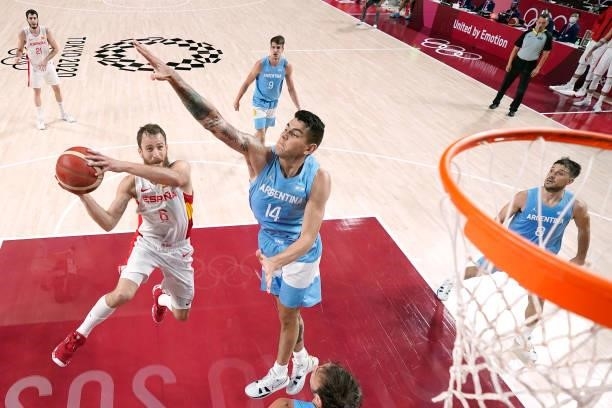 Sergio Rodriguez of Team Spain drives to the basket against Gabriel Deck of Team Argentina during the first half of a Men's Preliminary Round Group C...