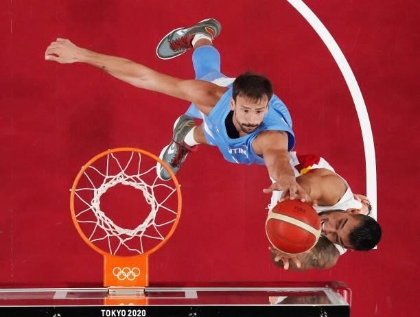 Marcos Delia of Team Argentina and Willy Hernangomez of Team Spain jump to grab a rebound during the first half of a Men's Preliminary Round Group C...
