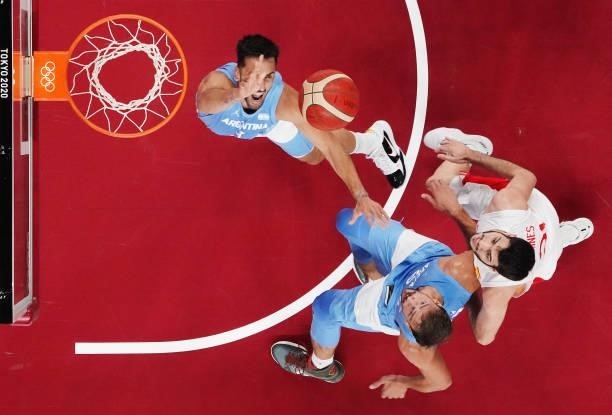 Facundo Campazzo of Team Argentina and teammate Marcos Delia jump for a rebound against Alejandro Abrines Redondo of Team Spain during the first half...
