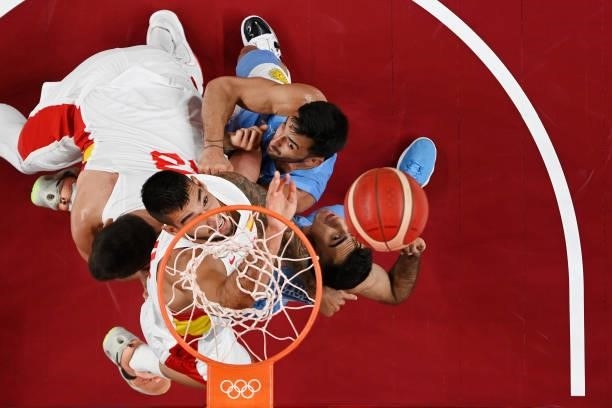 Willy Hernangomez and Marc Gasol of Team Spain fight for possession of a rebound with Facundo Campazzo and Luis Scola of Team Argentina during the...
