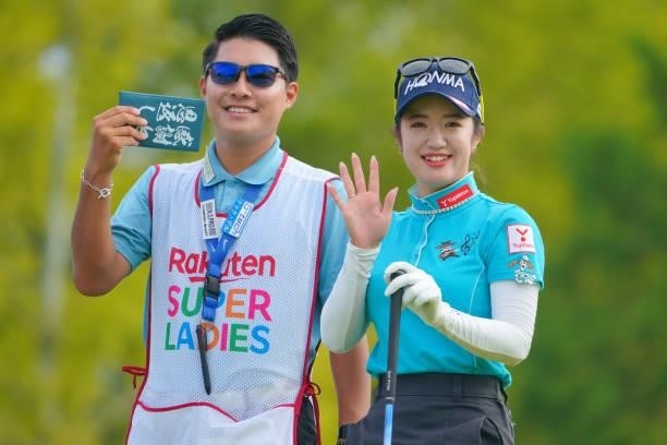 Nanoko Hayashi of Japan poses with her caddie on the 10th tee during the second round of Rakuten Super Ladies at Tokyu Grand Oak Golf Club on July...