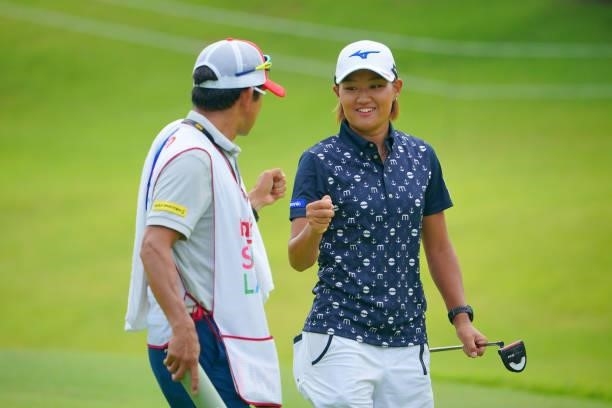 Mao Nozawa of Japan fist bumps with her caddie after the birdie on the 10th green during the second round of Rakuten Super Ladies at Tokyu Grand Oak...