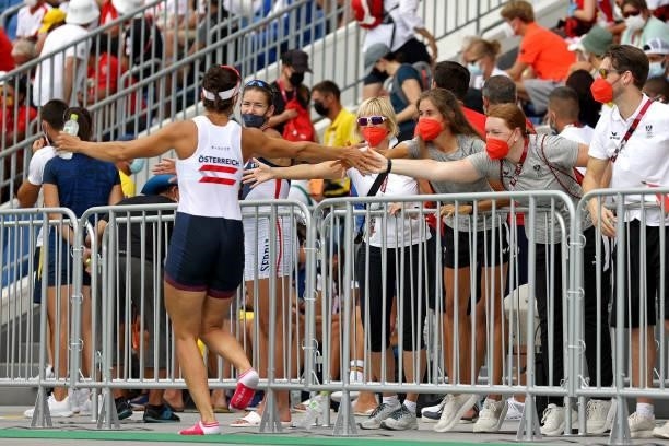 Magdalena Lobnig of Team Austria gives high fives after winning the bronze medal during the Women's Single Sculls Final A on day seven of the Tokyo...