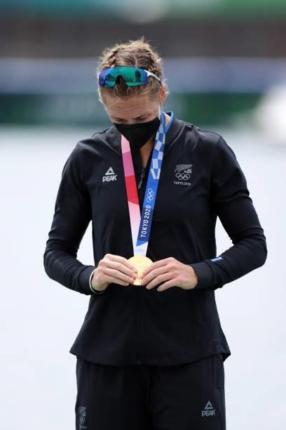 Gold medalist Emma Twigg of Team New Zealand looks down at her medal during the medal ceremony for the Women's Single Sculls Final A on day seven of...