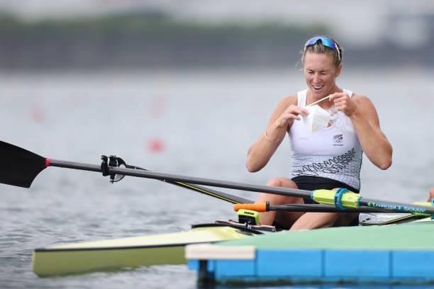 Gold medalist Emma Twigg of Team New Zealand puts on her mask after the Women's Single Sculls Final A on day seven of the Tokyo 2020 Olympic Games at...