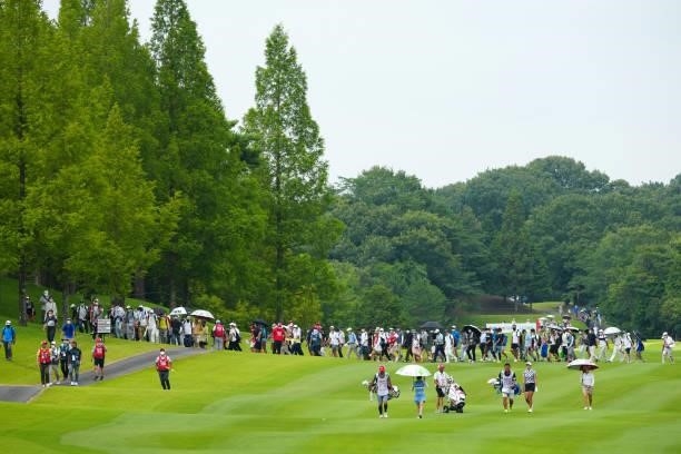 Yuna Nishimura, Erika Hara and Mone Inami of Japan are followed by fans on the 18th hole during the second round of Rakuten Super Ladies at Tokyu...