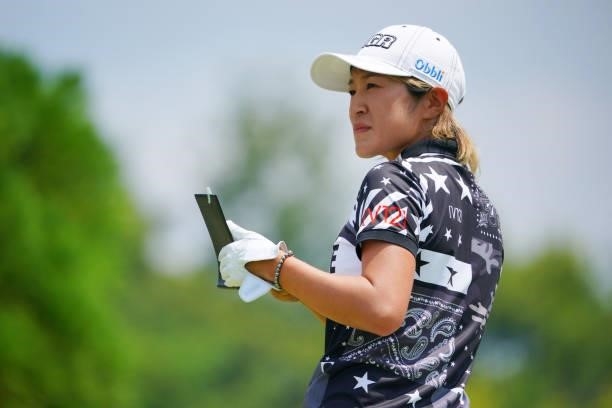 Asako Fujimoto of Japan checks her yardage book on the 1st tee during the second round of Rakuten Super Ladies at Tokyu Grand Oak Golf Club on July...