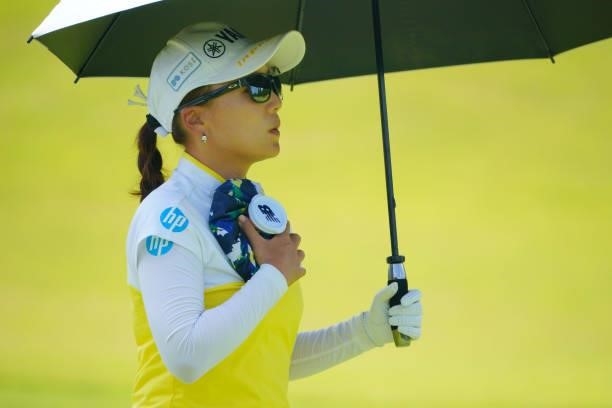 Chie Arimura of Japan puts an ice bag onto her chest to cool herself down on the 1st hole during the second round of Rakuten Super Ladies at Tokyu...