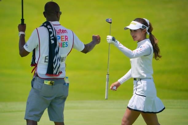 Reika Usui of Japan fist bumps with her caddie after the birdie on the 2nd green during the second round of Rakuten Super Ladies at Tokyu Grand Oak...