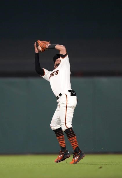 Thairo Estrada of the San Francisco Giants catches a short fly ball off the bat of Matt Beaty of the Los Angeles Dodgers in the top of the seventh...