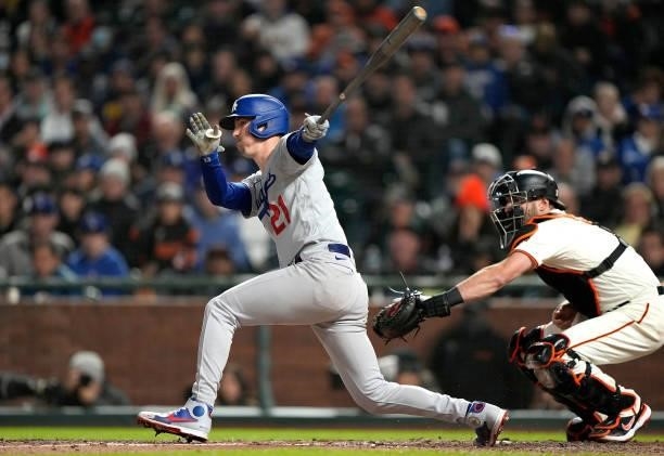 Walker Buehler of the Los Angeles Dodgers hits into a fielders choice and gets an RBI with AJ Pollock scoring from third base against the San...