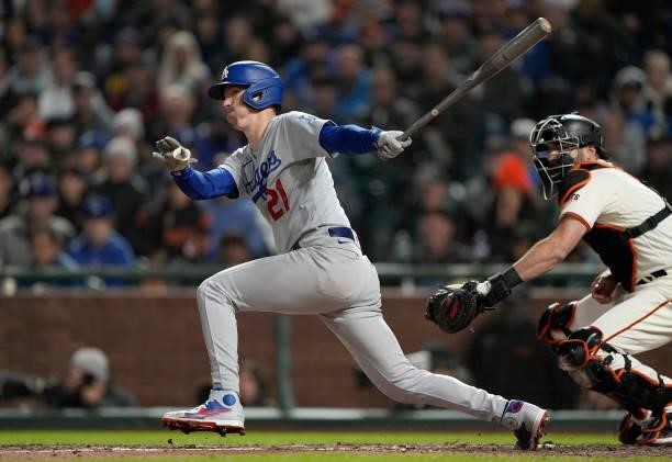 Walker Buehler of the Los Angeles Dodgers hits into a fielders choice and gets an RBI with AJ Pollock scoring from third base against the San...