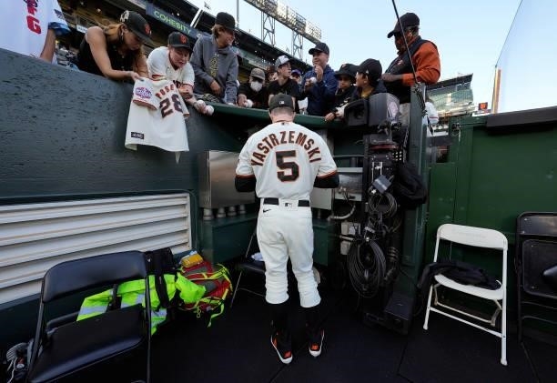 Mike Yastrzemski of the San Francisco Giants signs autographs for fans prior to the game against the Los Angeles Dodgers at Oracle Park on July 28,...