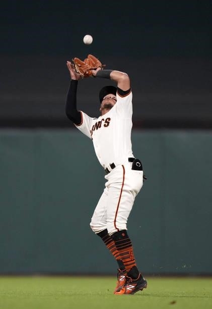 Thairo Estrada of the San Francisco Giants catches a short fly ball off the bat of Matt Beaty of the Los Angeles Dodgers in the top of the seventh...