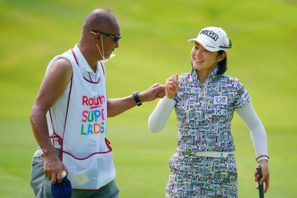Rie Tsuji of Japan fist bumps with her caddie after the birdie on the 7th green during the second round of Rakuten Super Ladies at Tokyu Grand Oak...