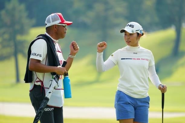 Mamiko Higa of Japan fist bumps with her caddie after holing out on the 18th green during the second round of Rakuten Super Ladies at Tokyu Grand Oak...