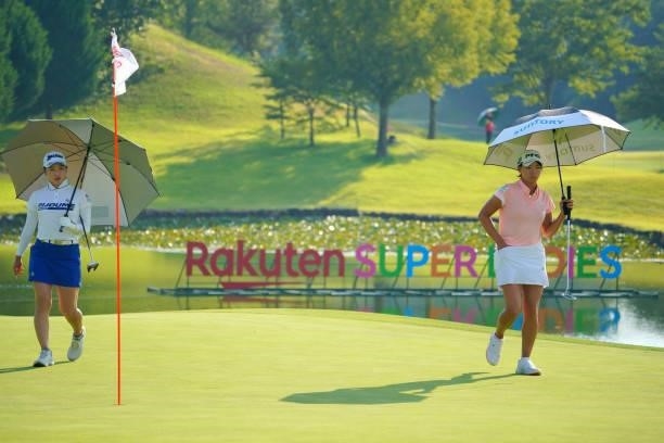 Sakura Koiwai and Hinako Shibuno of Japan are seen on the 18th green during the second round of Rakuten Super Ladies at Tokyu Grand Oak Golf Club on...