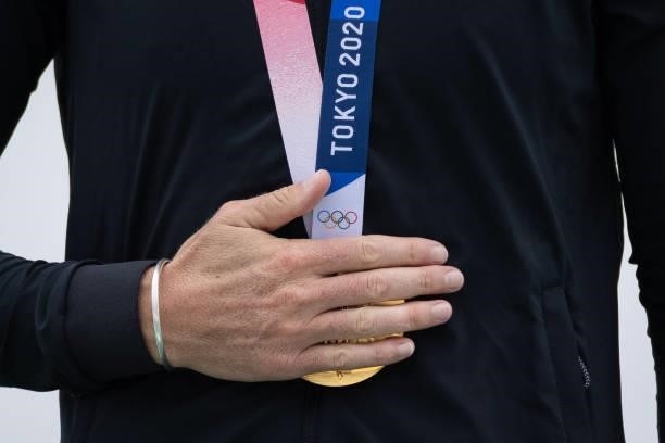 Gold medalist Emma Twigg of Team New Zealand clasps her medal during the medal ceremony for the Women's Single Sculls Final A on day seven of the...